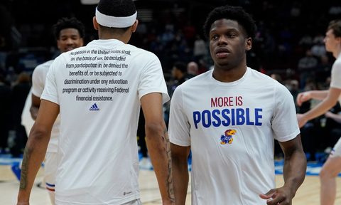 Kansas University Jayhawk basketball players wearing the new Adidas 'More Is Possible' warmup shirts.