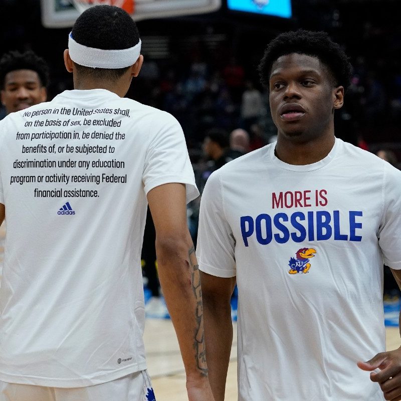 Kansas University Jayhawk basketball players wearing the new Adidas 'More Is Possible' warmup shirts.