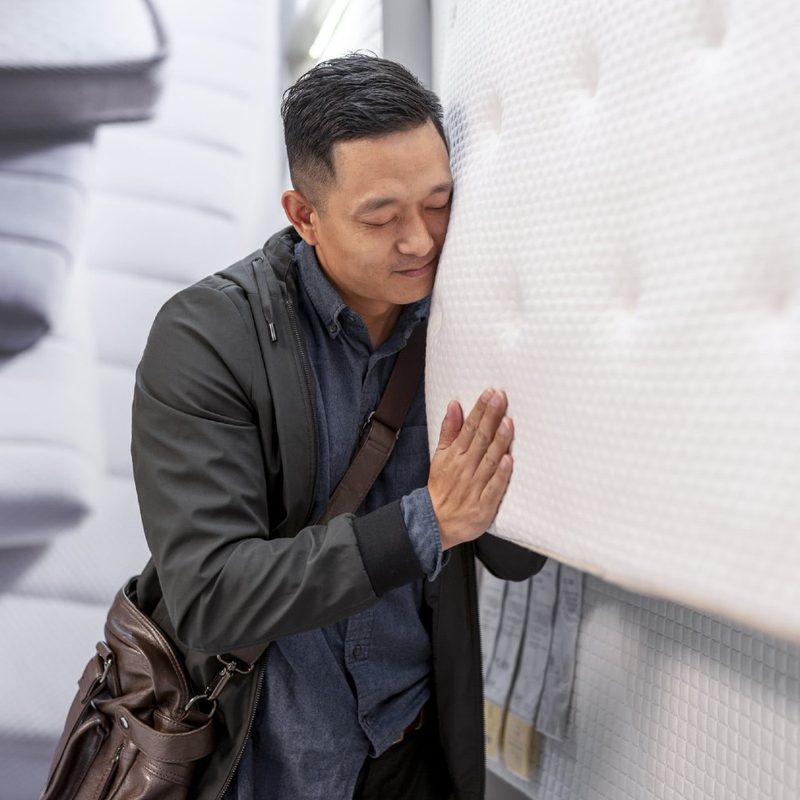 A man shops for a new mattress