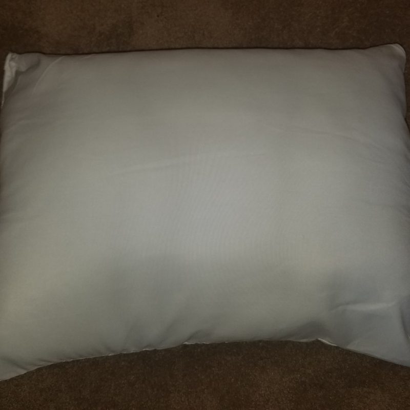 A white pillow lies on the floor.
