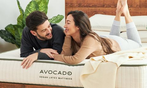 A couple lying on an Avocado Vegan Latex mattress.