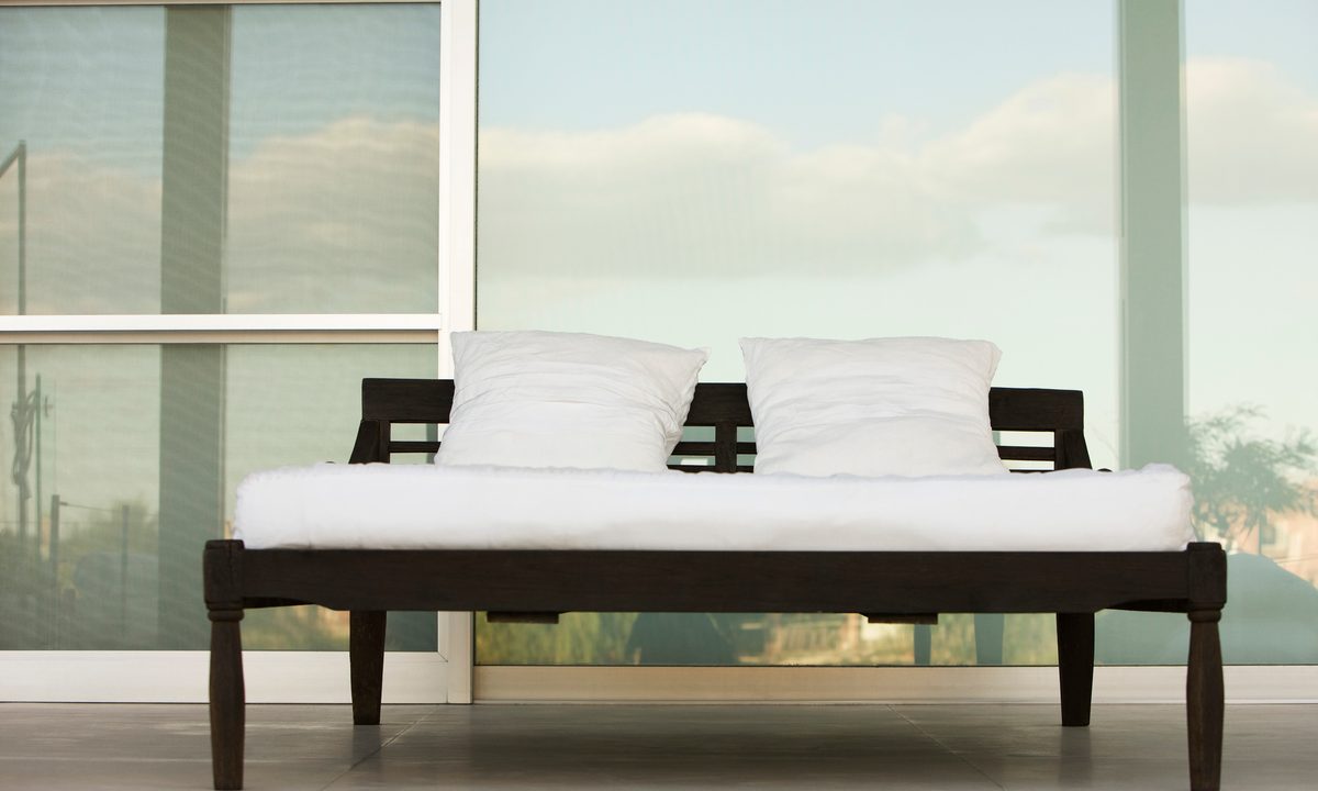 Bed on outdoor patio at resort.