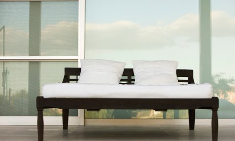 Bed on outdoor patio at resort.