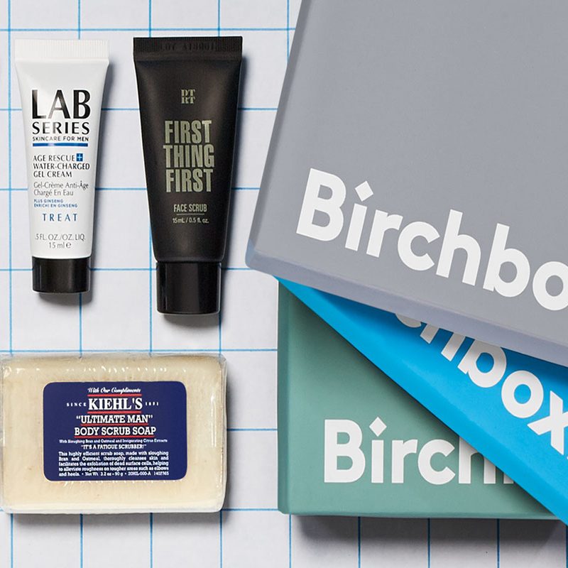 Three Birchbox boxes with skincare and grooming products.