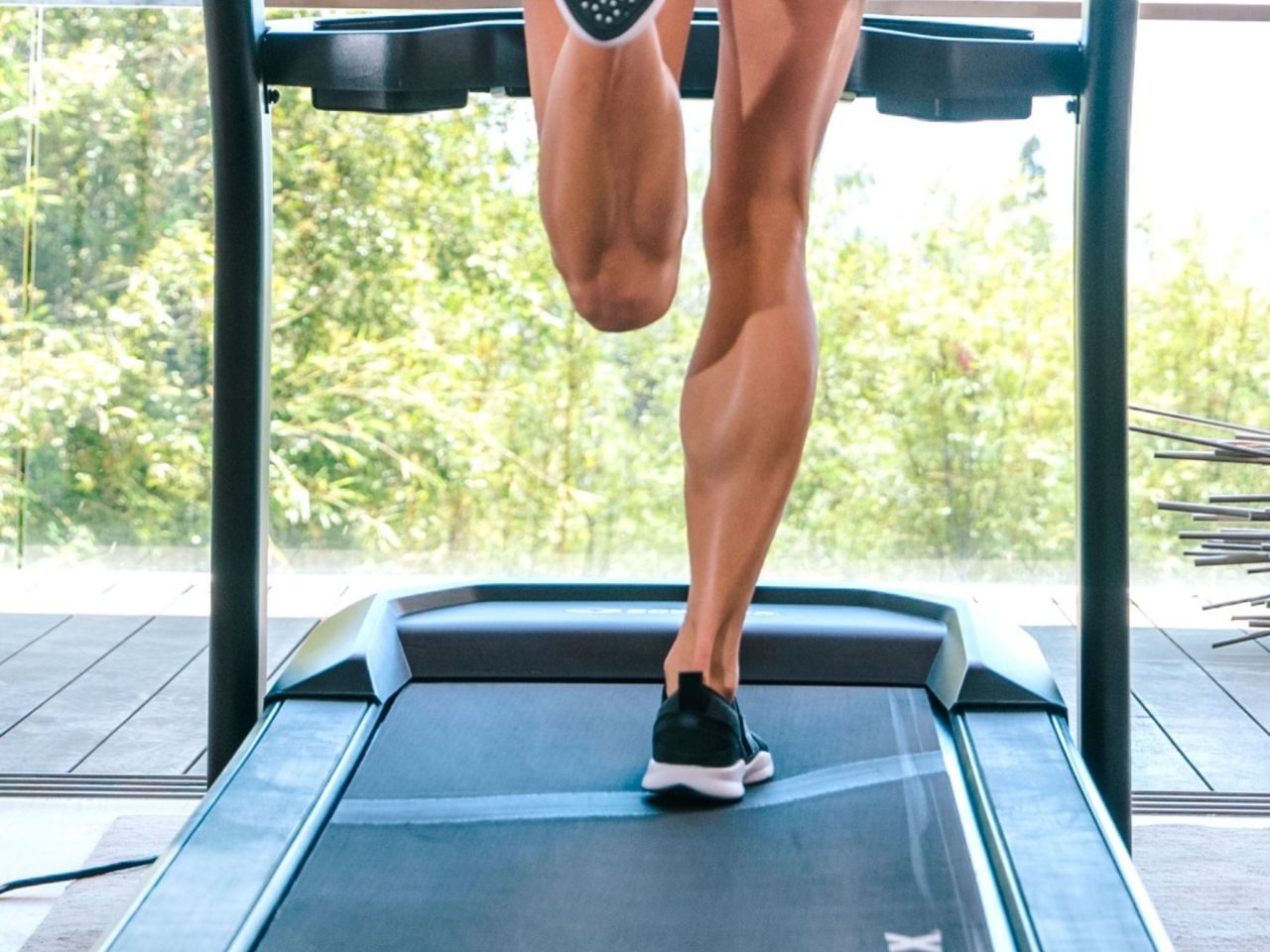 Person running on Bowflex BXT6 treadmill.