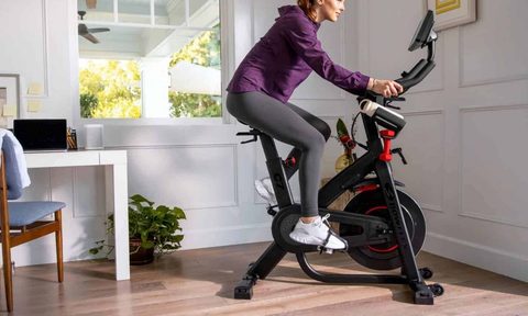 Woman using Bowflex C7 exercise bike.