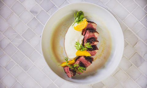 Chanson Le Salon duck a l'orange on white plate.