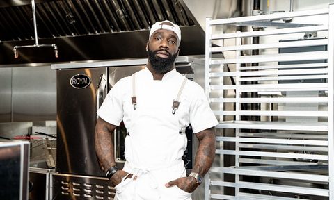 Chef Tobias Dorzon standing solo in kitchen.
