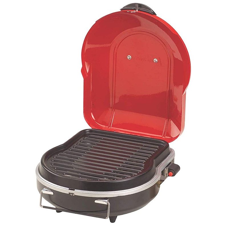 Coleman Fold n Go propane grill with red lid.