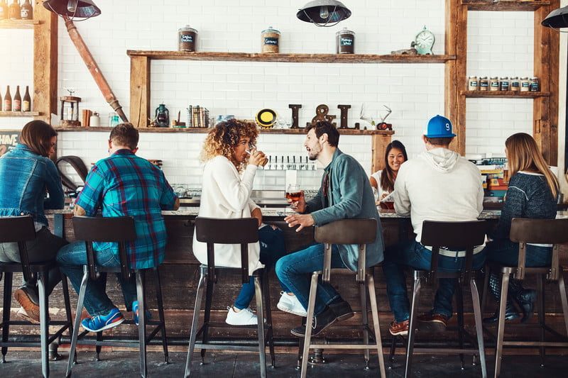 Couples having a good time at a bar.