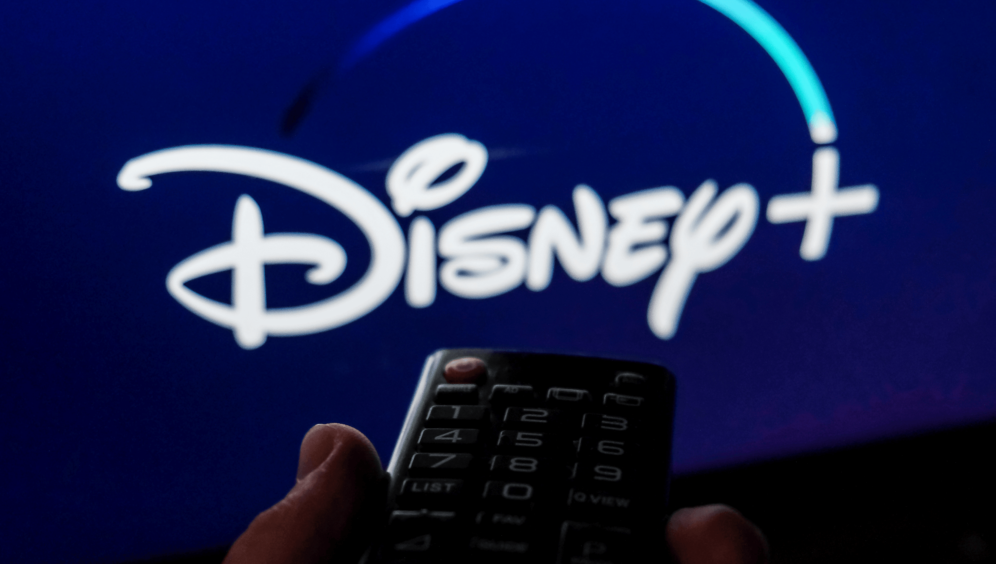 A remote with Disney Plus in the background.