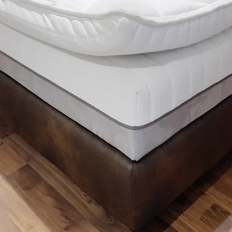 A latex mattress on a bed.