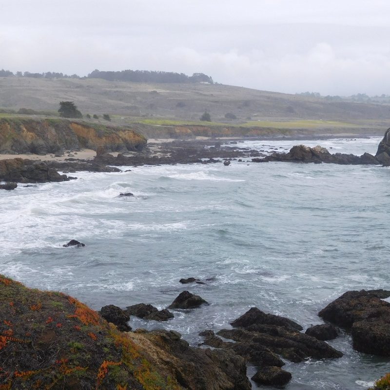 A view of the waves and the mountains at Pescadero State Beach in Pescadero, California.