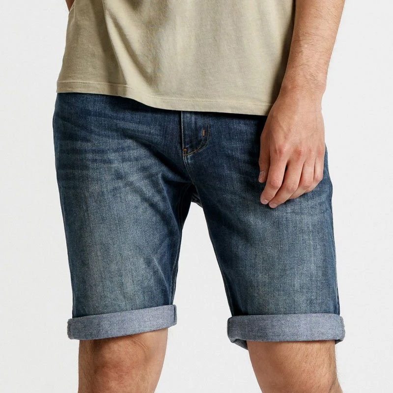 A man wearing the Duer Performance Denim Commuter jean shorts.