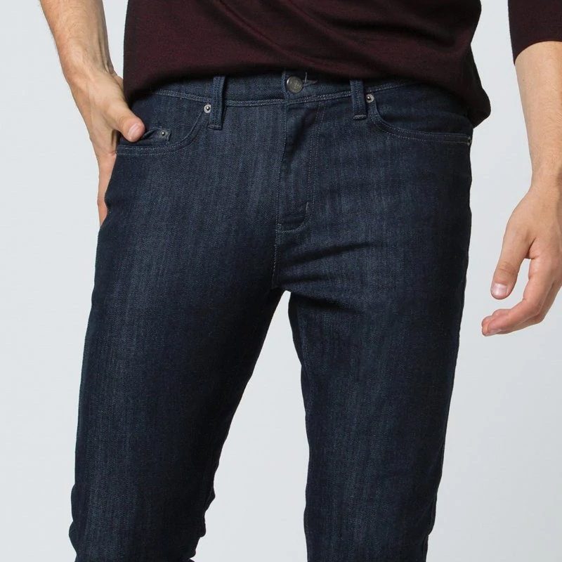 A man wearing the Duer Performance Denim slim fit jeans.