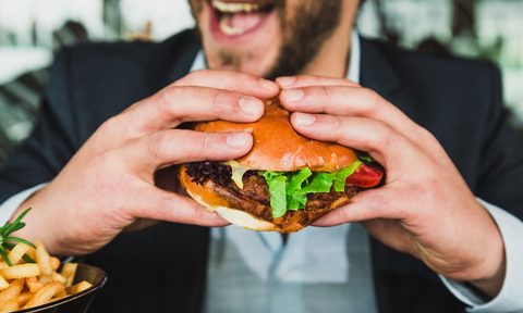 Man eating a big burger.