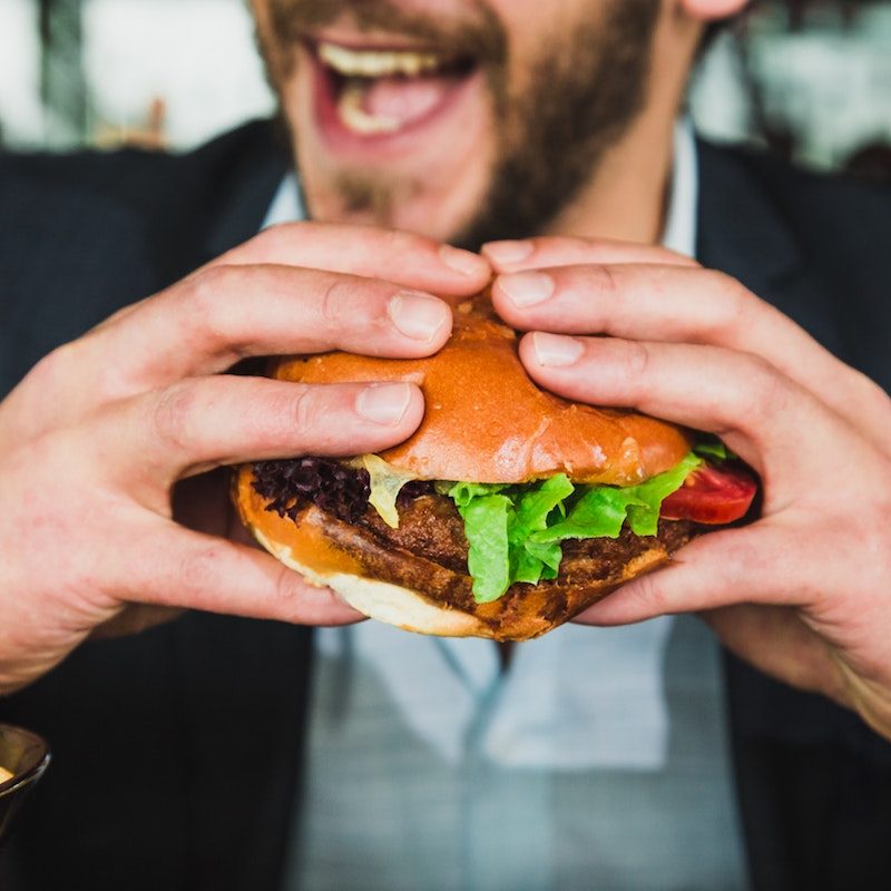Man eating a big burger.