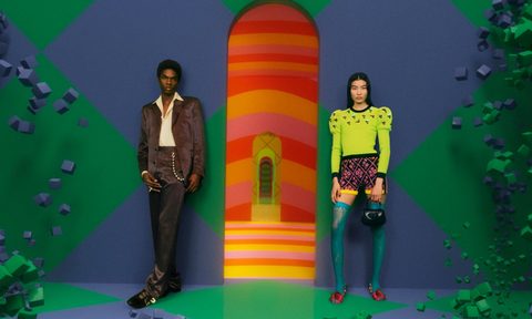 Gucci models stand at the entrance to the Vault, the luxury apparel company's new metaverse venture offering vintage goods.