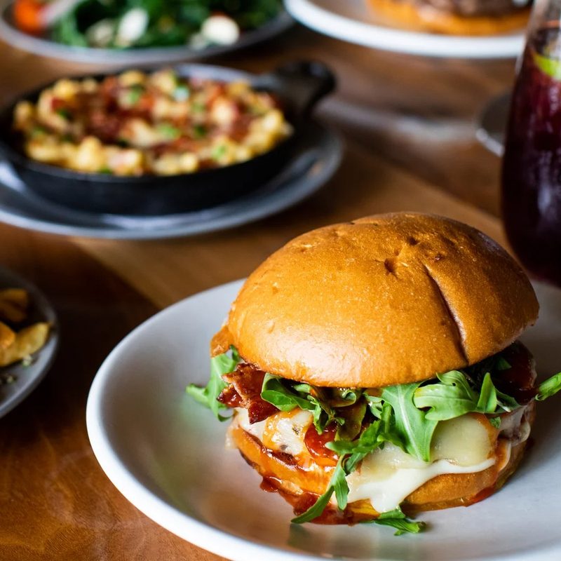 A table full of food at The Cut Handcrafted Burgers in Irvine, California.