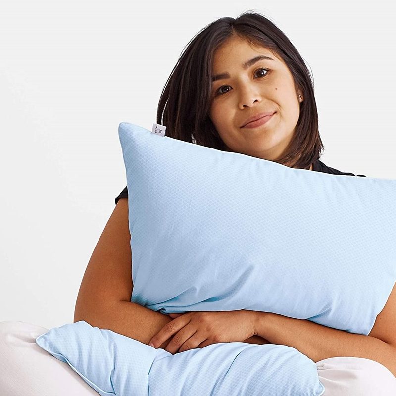 A woman hugging a blue Helix pillow.
