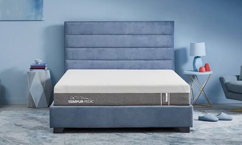 The Tempur-Pedic HERO Cloud mattress on a blue bed in a blue bedroom.