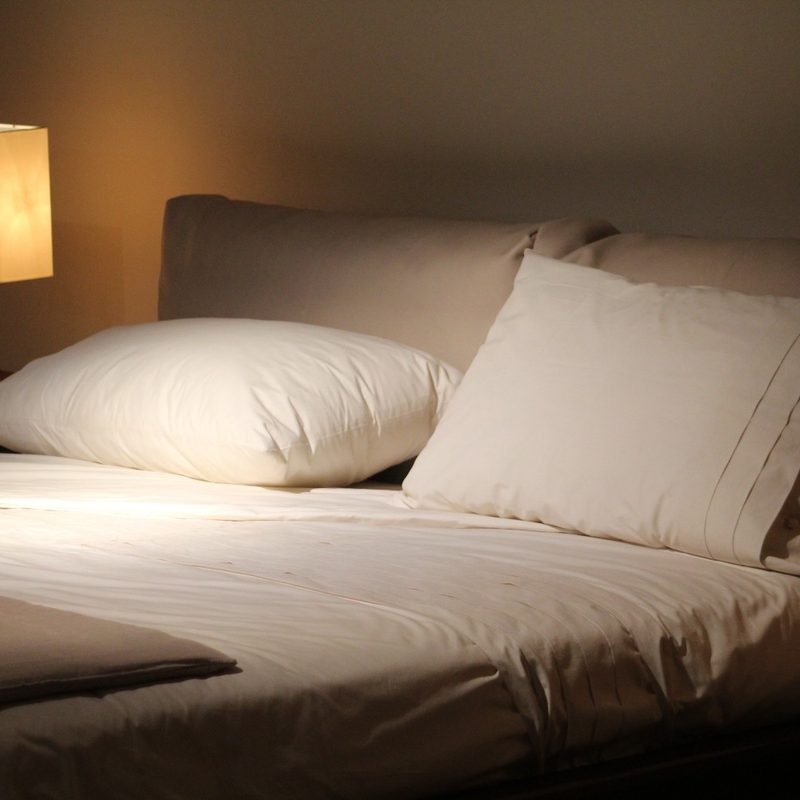 Pillows lie on the bed in a bedroom