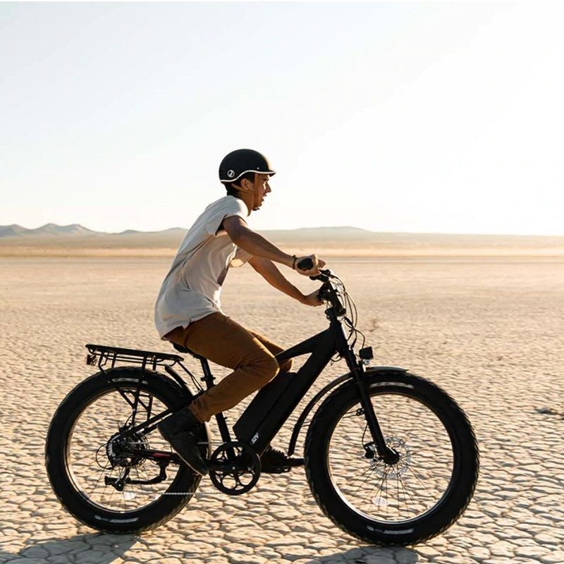 A man riding the Juiced RipCurrent S Ebike through the desert.