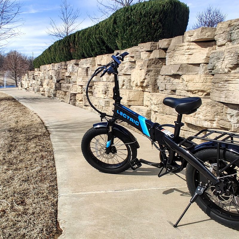 A Lectric XP 2.0 Black electric bike on an outdoor walking path.