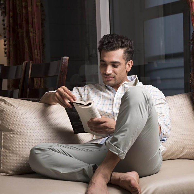 A man reads a book at home