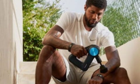 Man using a massage gun.