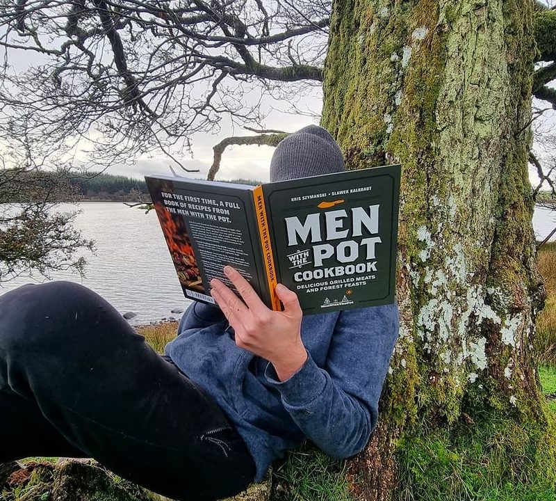 Men With The Pot cookbook being read outside.