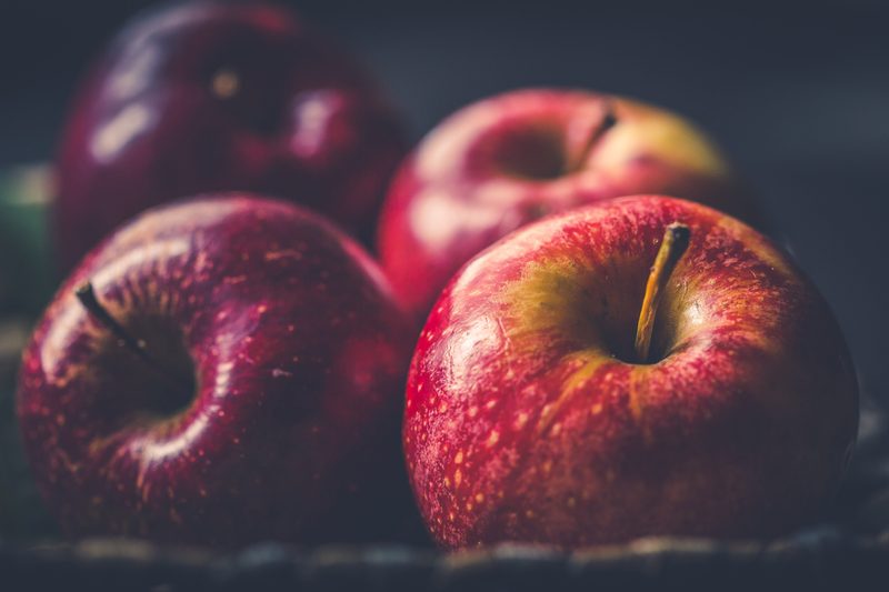 Red apples laying on surface