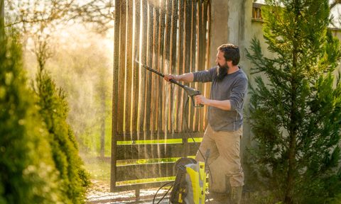 Man using a pressure washer.