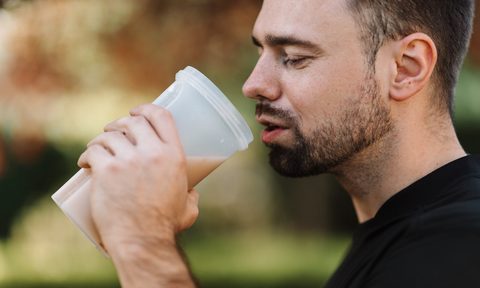 Man drinking a protein shake before exercising.