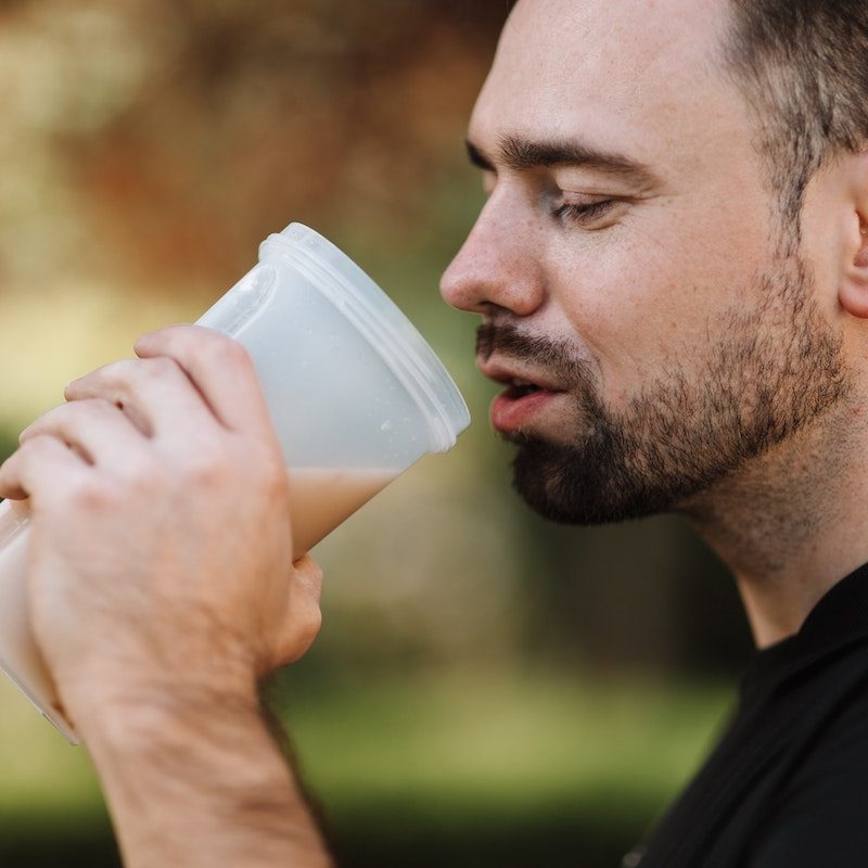 Man drinking a protein shake before exercising.