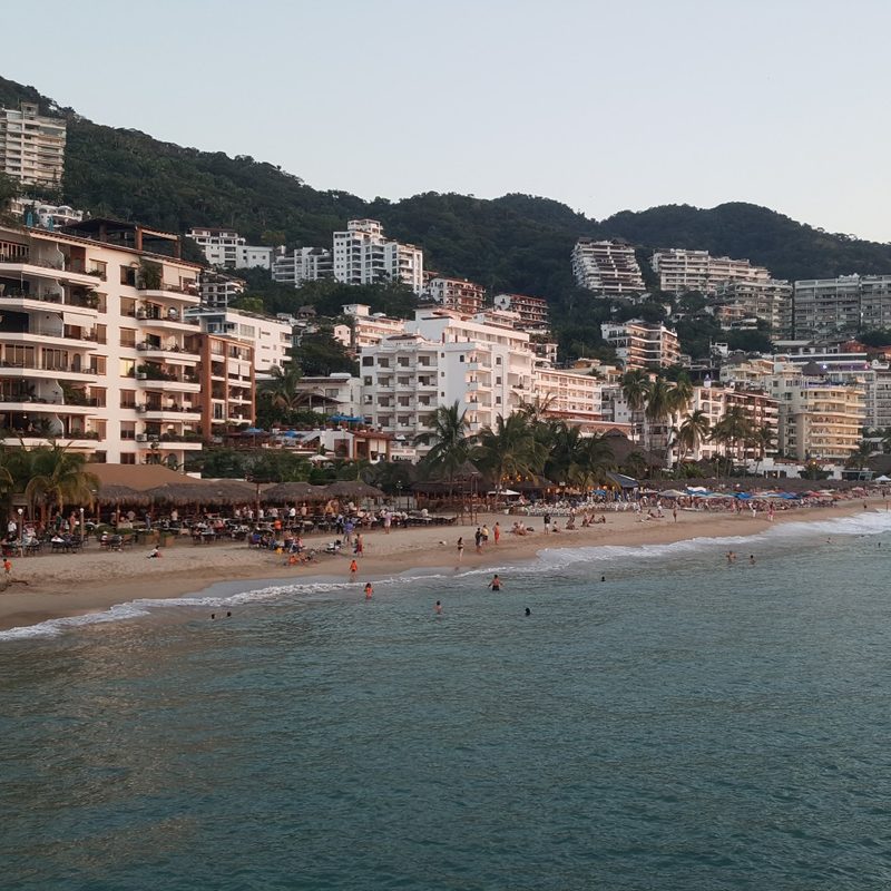 A view of the beach, hotels, and the mountains in Puerto Vallarta, Mexico.