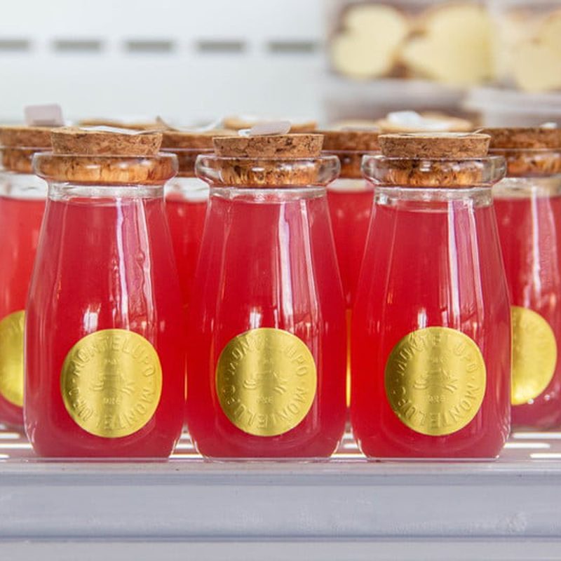 Several bottles of Rhubarb-Arita displayed on a tray.
