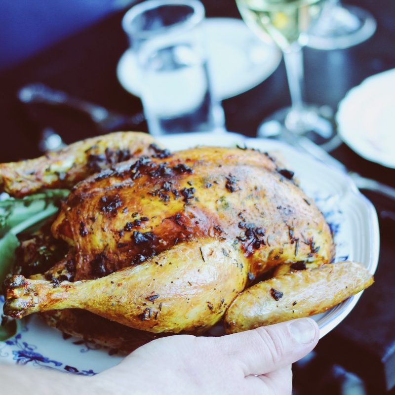 A roasted chicken is served on a plate
