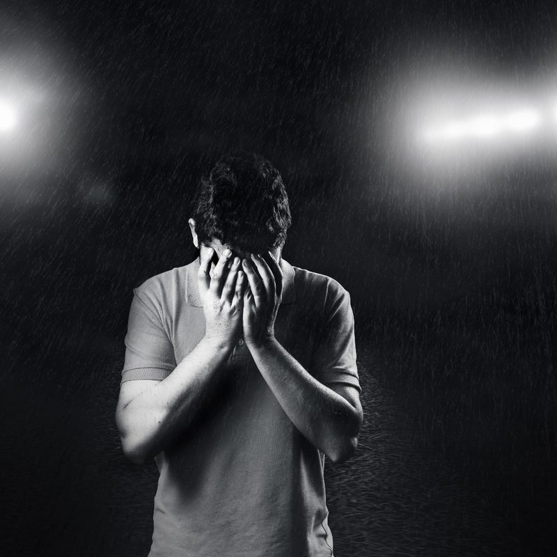 A man cries alone.