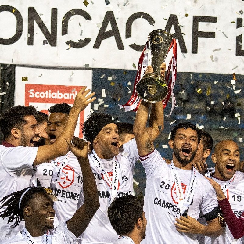 Deportivo Saprissa celebrates its CONCACAF League champion trophy with teammates.