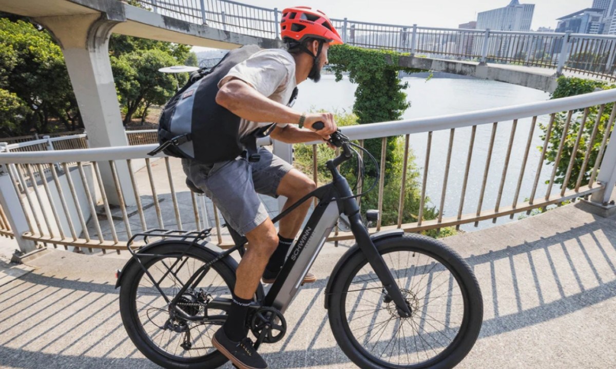 A man riding the Schwinn Coston DX ebike.