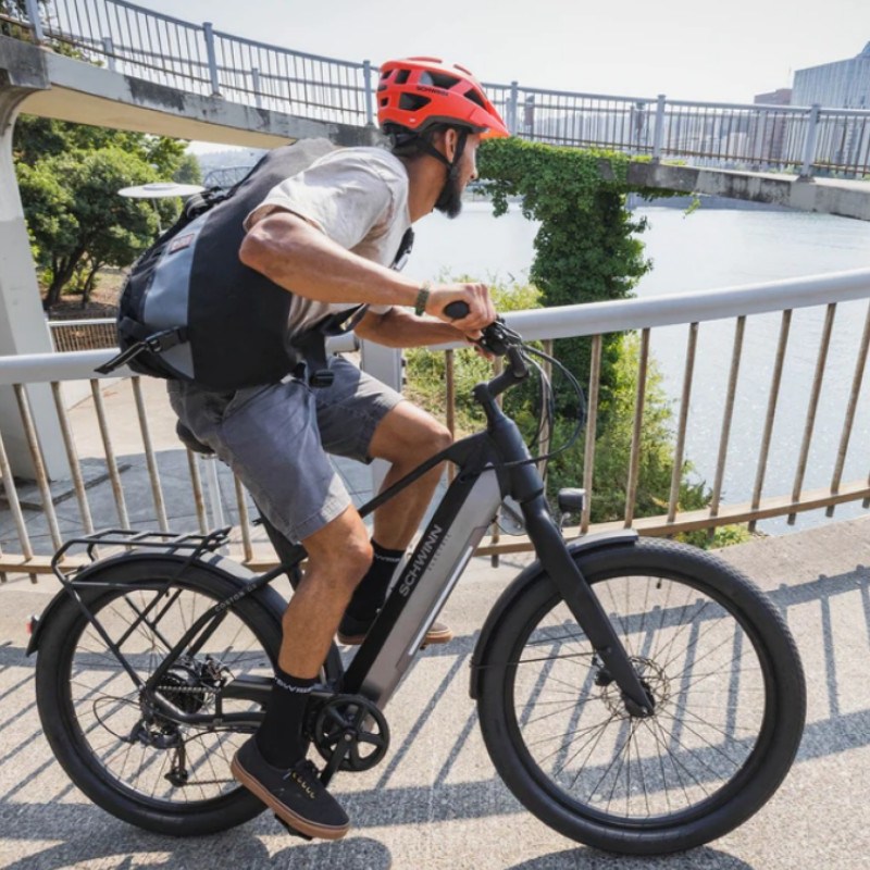 A man riding the Schwinn Coston DX e-bike.