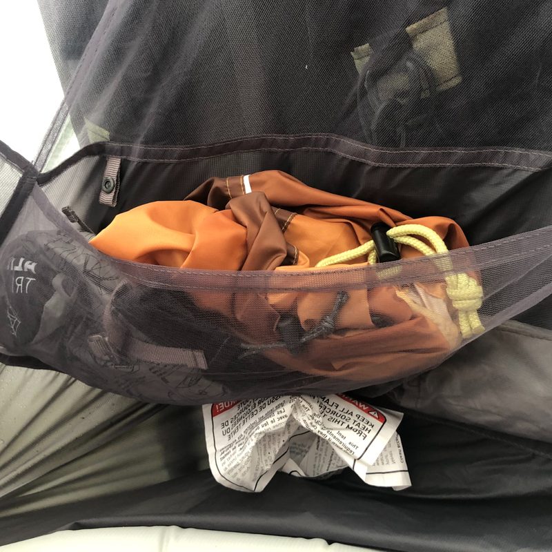 Interior storage pocket on a one-person tent for backpacking.