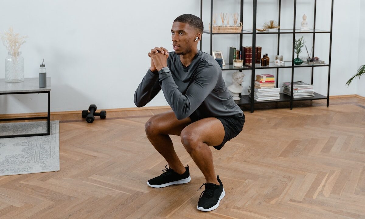 Man doing squats at home