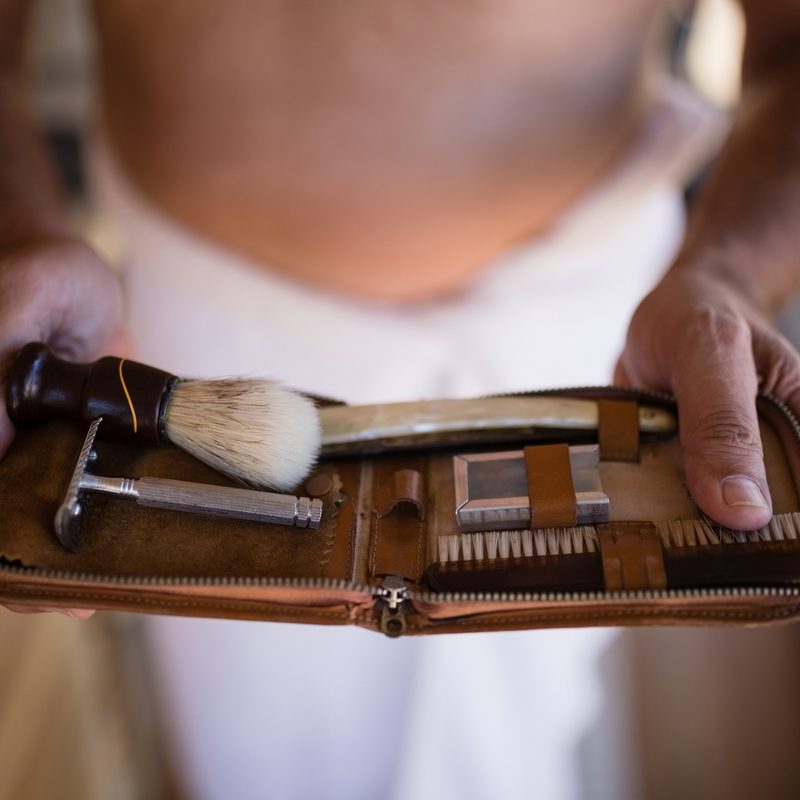 Man holding a shaving kit