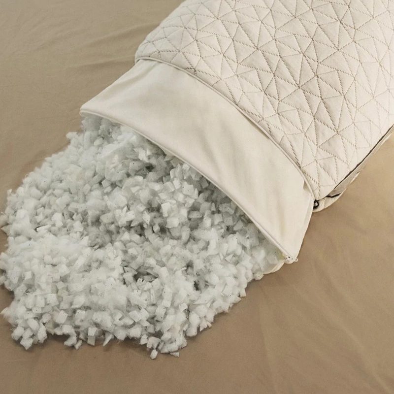 An overhead shot of a Coop Home Goods Eden Pillow with memory foam and microfiber fill on brown bedsheet.