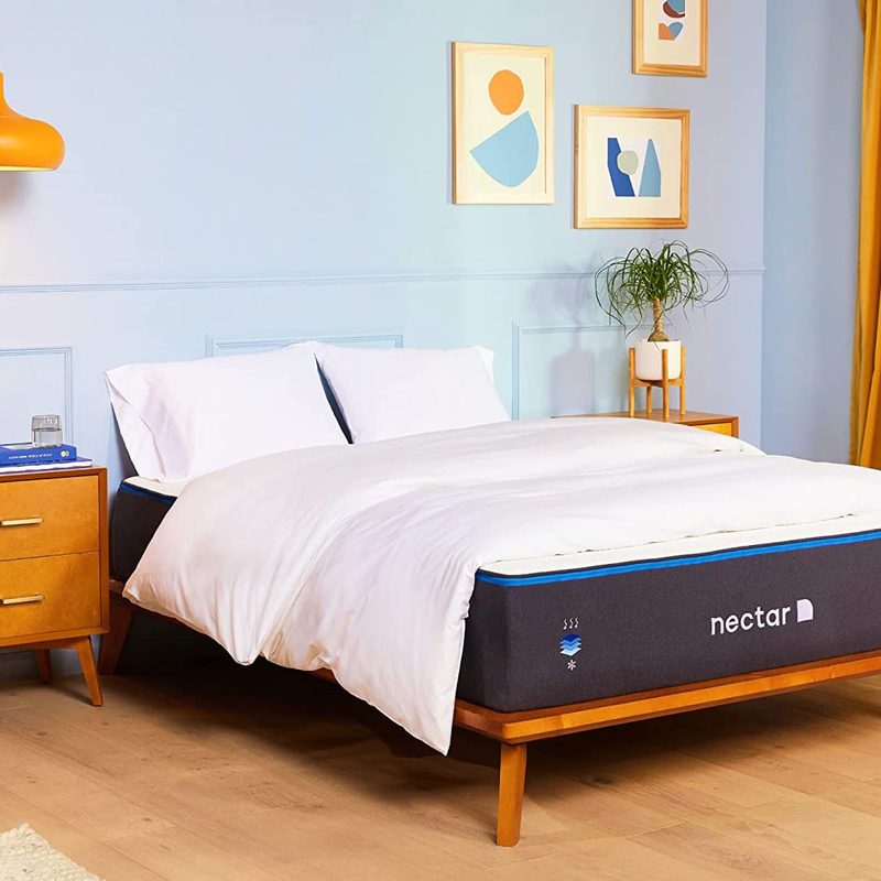 A Nectar mattress on a bed in a brightly lit bedroom.