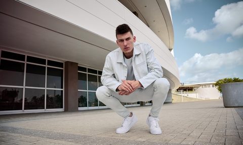 Fashionable Miami Heat guard Tyler Herro sporting white Hudson Jeans.