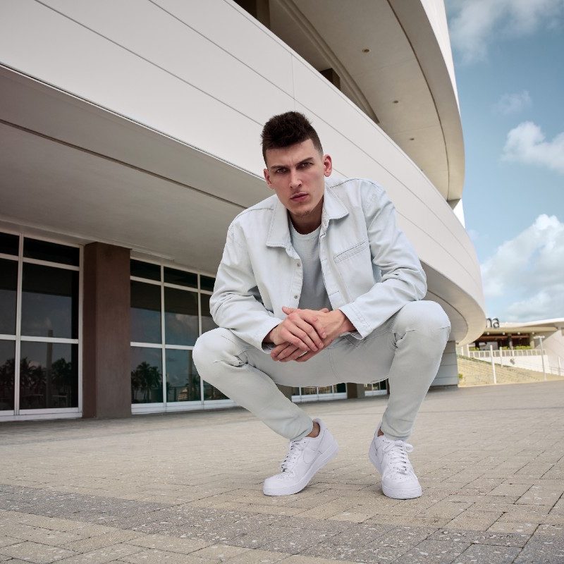 Fashionable Miami Heat guard Tyler Herro sporting white Hudson Jeans.