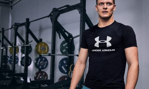 Mick Shumacher wearing Under Armour shirt in gym.